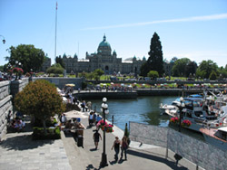 Victoria BC People walking along the walkway of Victoria's Inner Harbour